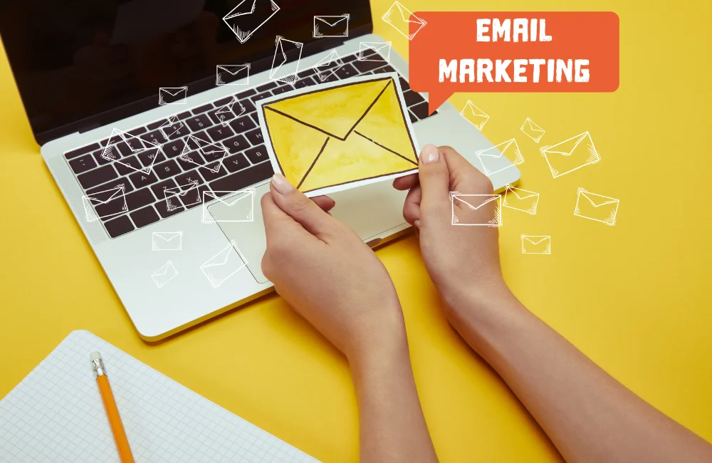 cropped image of woman holding envelope sign near laptop