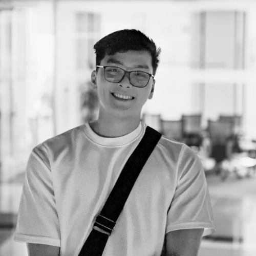 A black and white photo of a man wearing glasses